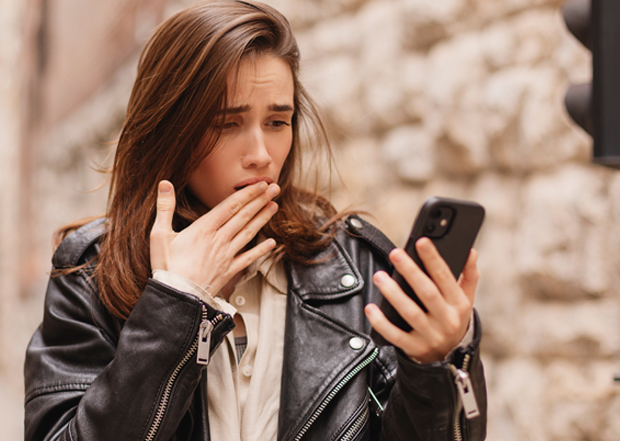 woman looking at phone confused expressions