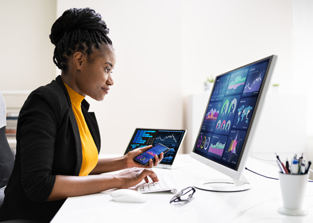 african-american-woman-reading-finacial-graphs-on-computer